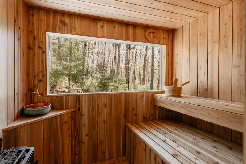 Wooden sauna with panoramic forest view